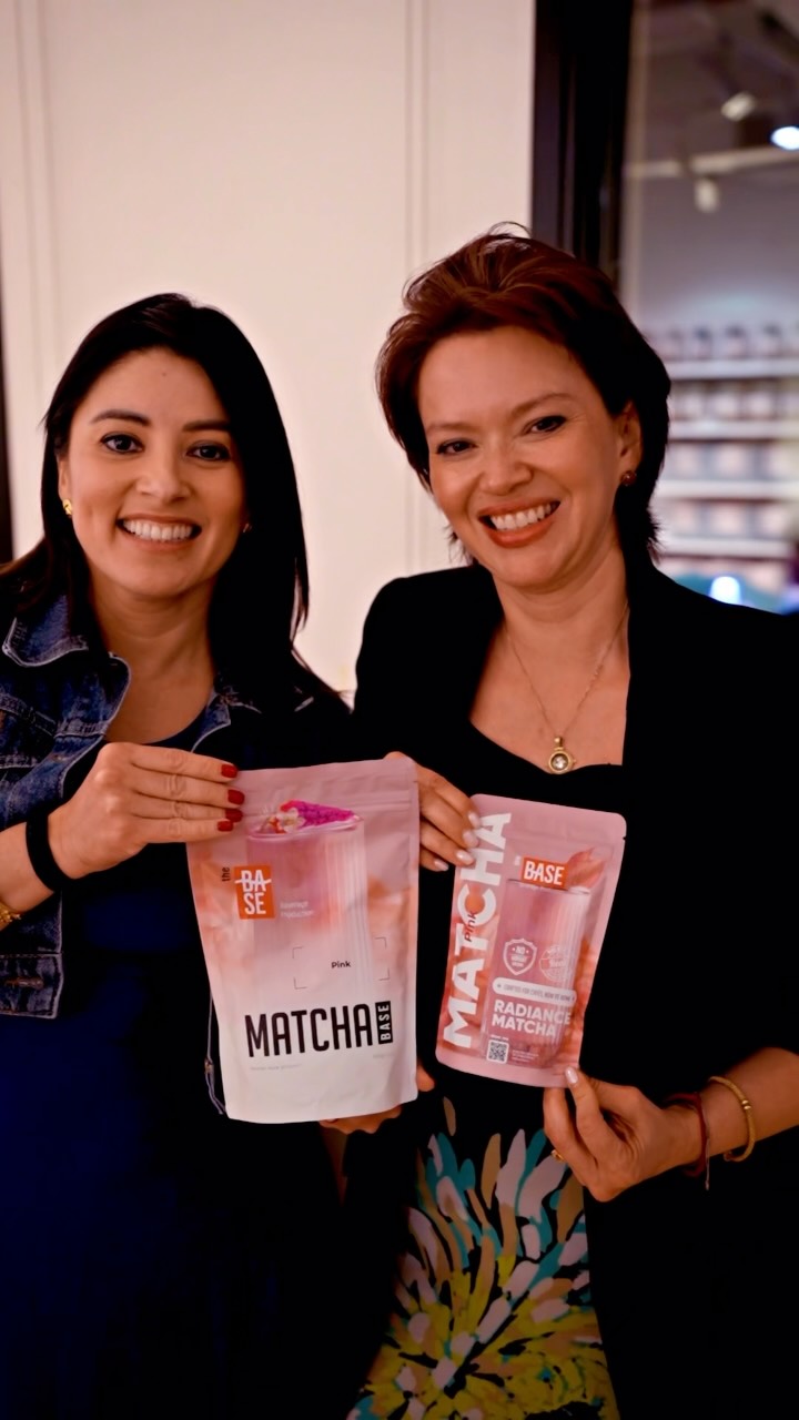 Two people holding The Base Matcha pouches